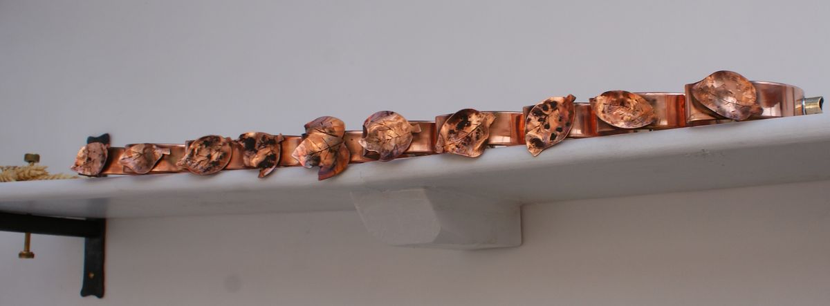 detailed copper gutter bracket with scroll