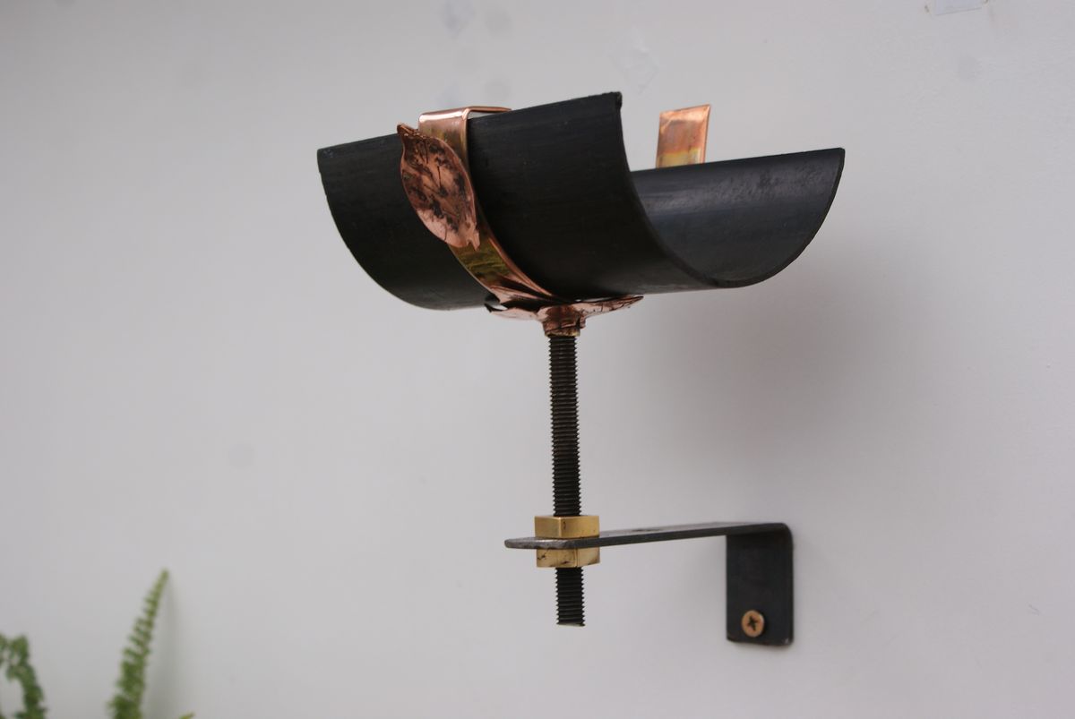 artisan copper gutter support with etched leaf