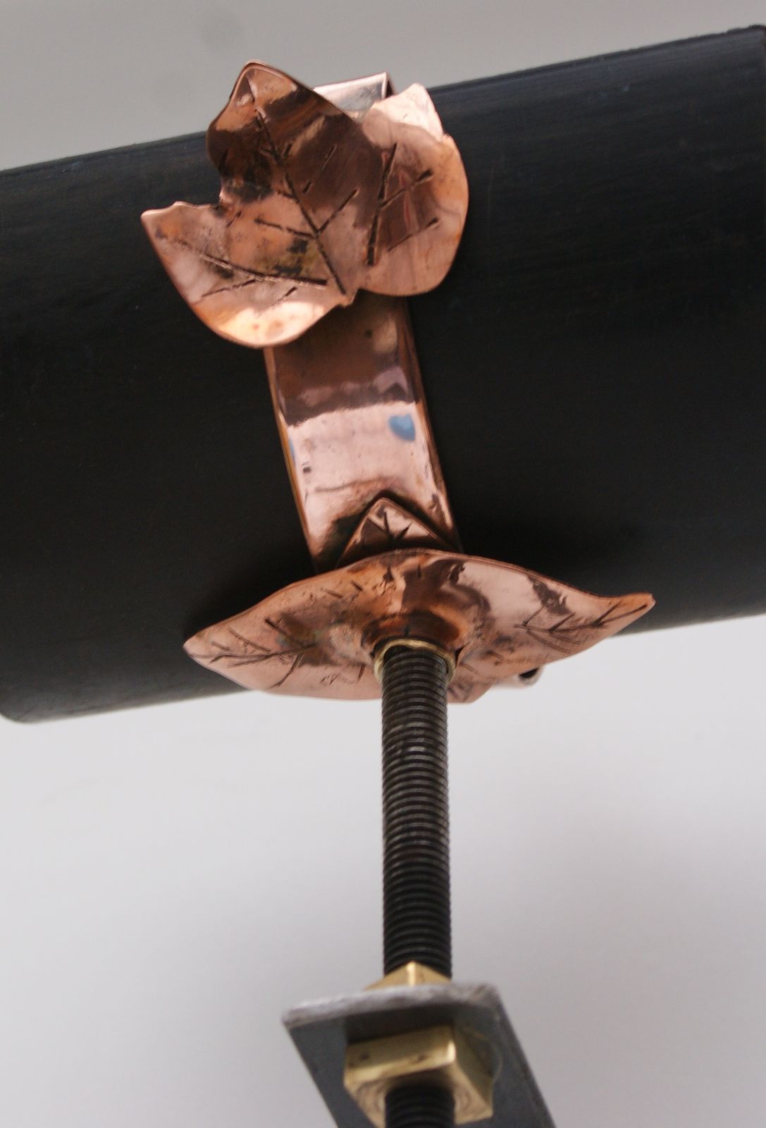 rustic copper gutter strap leaf motif