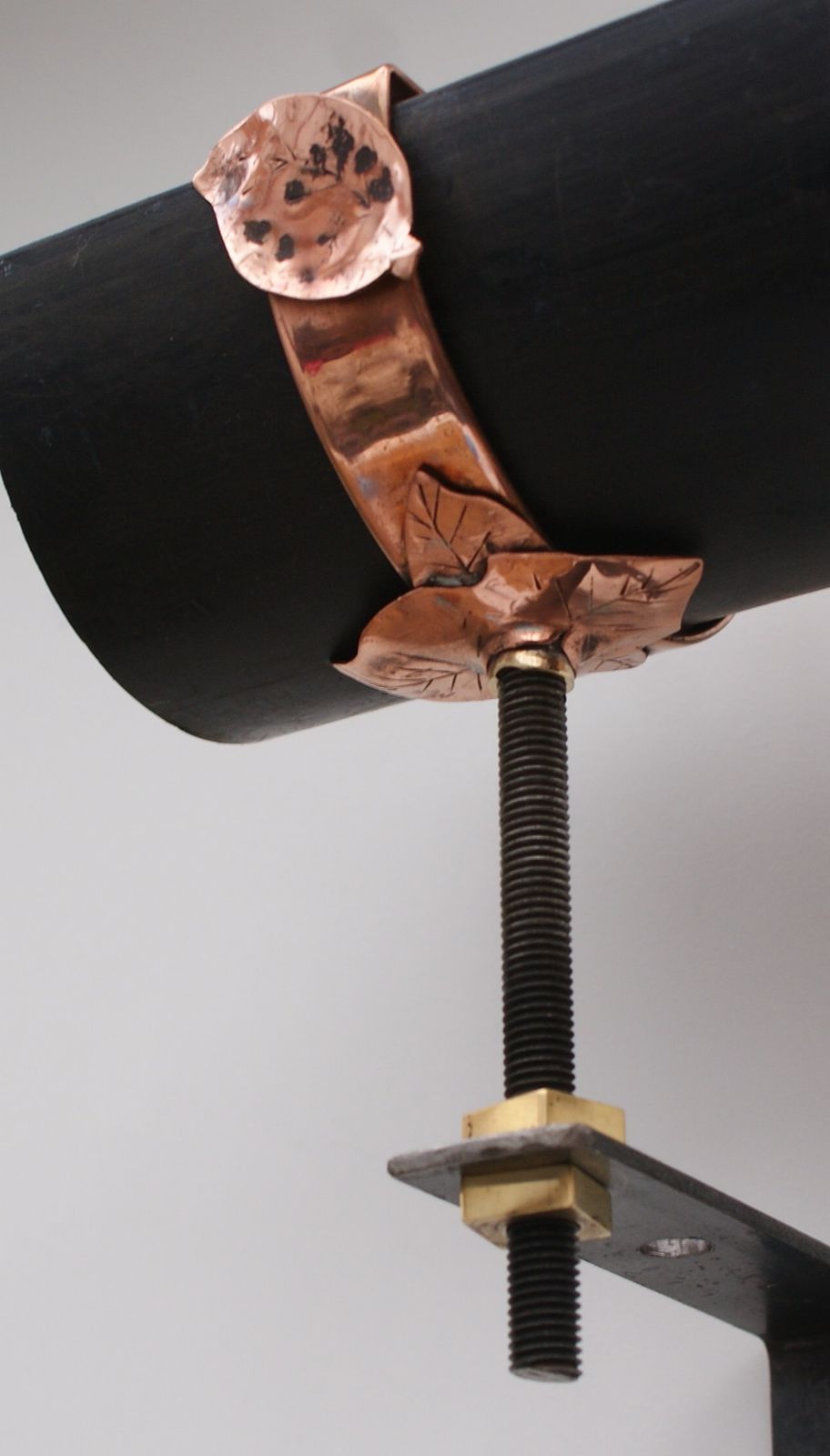 decorative copper gutter clamp with leaf detail